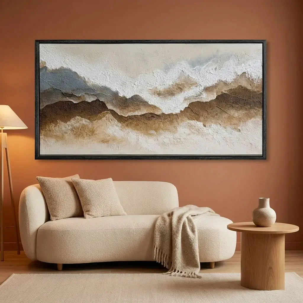 Living room with a beige sofa, wooden side table, and abstract mountain painting on an orange wall.