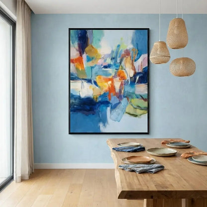 Dining room with abstract painting on the wall and wooden table.