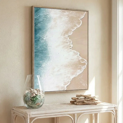 Framed abstract artwork on a wall above a white console table with decorative items.