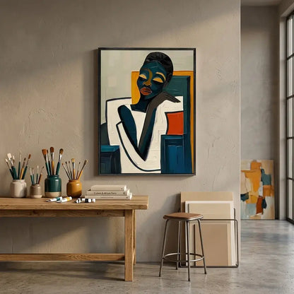 Artistic interior setting with a painting of a stylized figure on a wall, a wooden table with art supplies, and a chair.