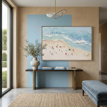 Modern interior with a painting of a beach scene, a vase with plants, and a console table.