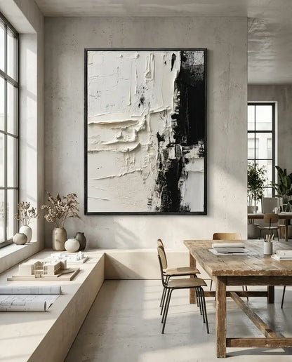 Modern interior with abstract art on the wall, wooden dining table, and chairs.