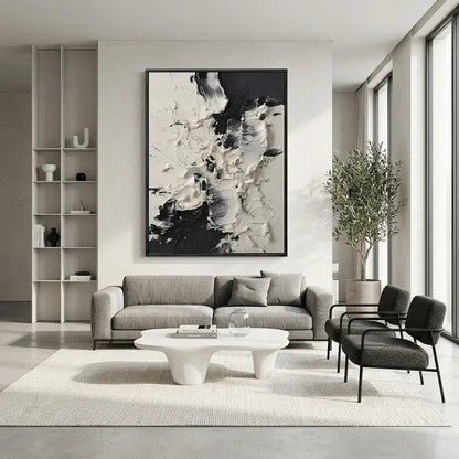 Modern living room with gray sofa, abstract art, and a plant.