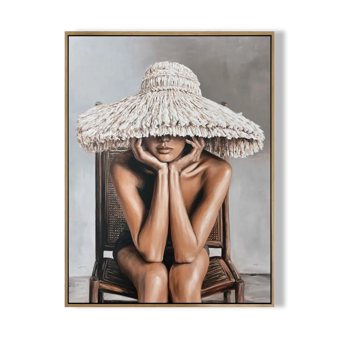 Framed artwork of a person wearing a large straw hat sitting on a chair.