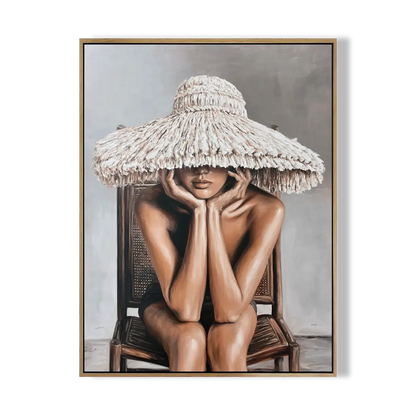 Framed artwork of a person wearing a large straw hat sitting on a chair.